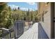 Back deck with table and chairs shows the beautiful scenery beyond at 10469 Christopher Dr, Conifer, CO 80433