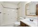 Clean bathroom featuring a shower-tub combo and vanity with dark wood at 10469 Christopher Dr, Conifer, CO 80433