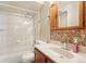 Bathroom with shower-tub combination, vanity and linoleum flooring at 10469 Christopher Dr, Conifer, CO 80433
