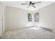 Bright bedroom with neutral carpet and two windows at 10469 Christopher Dr, Conifer, CO 80433