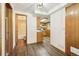 Hallway with Luxury vinyl plank flooring leads to bathroom and kitchen at 10469 Christopher Dr, Conifer, CO 80433