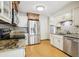 Bright kitchen with stainless steel appliances, granite countertops, and hardwood floors at 10469 Christopher Dr, Conifer, CO 80433