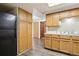 Kitchen featuring ample wood cabinets, a black fridge and luxury vinyl plank flooring at 10469 Christopher Dr, Conifer, CO 80433