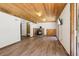 Living room features include wood paneling, brick fireplace, and laminate floors at 10469 Christopher Dr, Conifer, CO 80433