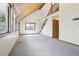 Sunlit living room featuring a staircase, high ceilings, and a wall of windows at 10469 Christopher Dr, Conifer, CO 80433