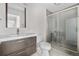 Modern bathroom featuring stylish vanity with a large mirror, toilet, and glass-enclosed shower at 1243 N Washington St # 308, Denver, CO 80203