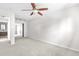 Empty bedroom with neutral carpet, ceiling fan and adjacent bathroom at 1243 N Washington St # 308, Denver, CO 80203