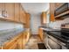 Modern kitchen with wood cabinets, stainless steel appliances, and granite countertops at 1243 N Washington St # 308, Denver, CO 80203