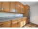 Efficient kitchen with wood cabinets, granite countertops, and a stainless steel refrigerator at 1243 N Washington St # 308, Denver, CO 80203
