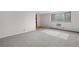 Bright living room with neutral carpeting, large window, and natural light at 1243 N Washington St # 308, Denver, CO 80203