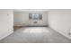 Bright living room with neutral carpeting, large window, and natural light at 1243 N Washington St # 308, Denver, CO 80203