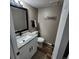 Bathroom with vanity featuring a granite countertop, updated fixtures, and a modern mirror at 2746 S Kenton Ct, Aurora, CO 80014