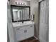 Modern bathroom featuring sleek vanity with white countertop, updated fixtures, and ample storage at 2746 S Kenton Ct, Aurora, CO 80014
