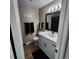 Bathroom features a new vanity with granite countertops, a black framed mirror, and new hardware at 2746 S Kenton Ct, Aurora, CO 80014
