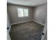 Cozy bedroom with plush carpeting, a bright window, and neutral walls, creating a comfortable retreat at 2746 S Kenton Ct, Aurora, CO 80014