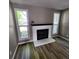 Cozy living room featuring fireplace flanked by two windows, complete with wood-look floors at 2746 S Kenton Ct, Aurora, CO 80014