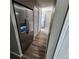 Hallway features a stainless steel refrigerator and wood-look floors, offering a clean and functional space at 2746 S Kenton Ct, Aurora, CO 80014