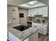 Bright kitchen with stainless steel appliances, granite countertops, and white cabinetry at 2746 S Kenton Ct, Aurora, CO 80014