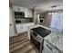 Bright kitchen features white cabinets, modern appliances, and granite countertops, ideal for cooking and entertaining at 2746 S Kenton Ct, Aurora, CO 80014