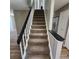 Carpeted stairs with white risers and a dark railing, leading to the upper level of the home at 2746 S Kenton Ct, Aurora, CO 80014