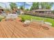 Well-kept backyard featuring a wooden deck and outdoor seating at 1304 S Harlan St, Lakewood, CO 80232