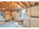Unfinished basement featuring washer, dryer, storage and exposed ceiling at 1304 S Harlan St, Lakewood, CO 80232