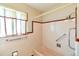 Pink bathroom with a shower/tub and a window at 1304 S Harlan St, Lakewood, CO 80232