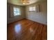 Bedroom features hardwood floors, neutral walls, and two windows providing natural light at 1304 S Harlan St, Lakewood, CO 80232