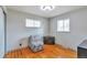 Neutral bedroom with hardwood floors, closet, and bright windows at 1304 S Harlan St, Lakewood, CO 80232