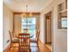 Cozy dining area with a charming chandelier, wooden table, and easy access to the backyard at 1304 S Harlan St, Lakewood, CO 80232