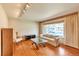 Bright living room with hardwood floors, a large window, and comfortable seating arrangement at 1304 S Harlan St, Lakewood, CO 80232