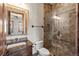 Bathroom featuring a tile shower, glass door, tile floors, granite countertop, and wood vanity at 9617 S Shadow Hill Cir, Lone Tree, CO 80124