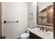 Powder bath featuring a wood vanity, granite countertop, sink, toilet, and mosaic tile detail at 9617 S Shadow Hill Cir, Lone Tree, CO 80124