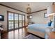 Bright bedroom with wood floors, plantation shutters, and a stylish light fixture at 9617 S Shadow Hill Cir, Lone Tree, CO 80124