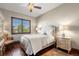 Bedroom with hardwood floors, neutral colored walls, and a window with wooden shutters at 9617 S Shadow Hill Cir, Lone Tree, CO 80124