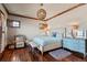 Bedroom with wood floors, shuttered windows, and a stylish light fixture at 9617 S Shadow Hill Cir, Lone Tree, CO 80124