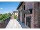 Outdoor deck featuring brick fireplace, metal railing, and neutral tone flooring at 9617 S Shadow Hill Cir, Lone Tree, CO 80124