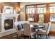 Charming dining room with a fireplace and bright, colorful stained glass windows at 9617 S Shadow Hill Cir, Lone Tree, CO 80124