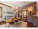 Elegant dining room with brick accent wall, wooden table, stylish chairs, and a wine display niche at 9617 S Shadow Hill Cir, Lone Tree, CO 80124
