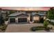 Beautiful single-story home with brick exterior, manicured landscaping, and a three-car garage at 9617 S Shadow Hill Cir, Lone Tree, CO 80124