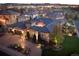 Stunning exterior view of home with dark roof, landscaped yard, and paved driveway leading to a two-car garage at 9617 S Shadow Hill Cir, Lone Tree, CO 80124
