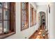 Hallway featuring wood floors, wood trim, and series of windows letting in an abundance of natural light at 9617 S Shadow Hill Cir, Lone Tree, CO 80124