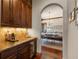 Butler's pantry leading to the dining room with a built-in coffee bar and wine fridge at 9617 S Shadow Hill Cir, Lone Tree, CO 80124