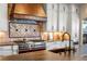 Custom kitchen with a professional range and copper accents at 9617 S Shadow Hill Cir, Lone Tree, CO 80124