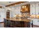 Stunning kitchen with a large island, modern appliances, and custom cabinetry with designer chandeliers and a copper hood at 9617 S Shadow Hill Cir, Lone Tree, CO 80124