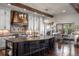 Spacious kitchen featuring wooden beams, stainless appliances, large island, and ample cabinets with adjacent dining space at 9617 S Shadow Hill Cir, Lone Tree, CO 80124
