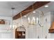 Close up of the modern designer chandeliers and wooden beams in the kitchen at 9617 S Shadow Hill Cir, Lone Tree, CO 80124