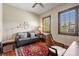 Living room with hardwood floors, seating, area rug and 2 windows with wood trim at 9617 S Shadow Hill Cir, Lone Tree, CO 80124