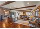 Open-concept living space with hardwood floors and wood beam ceiling flowing into modern kitchen at 9617 S Shadow Hill Cir, Lone Tree, CO 80124