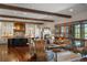 Open-concept living area with hardwood floors and wood beam ceiling flowing into modern kitchen at 9617 S Shadow Hill Cir, Lone Tree, CO 80124